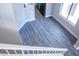 Clean staircase with gray wood-look flooring and white railing offering a modern transition between levels at 19511 N 76Th Ave, Glendale, AZ 85308