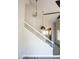 Bright staircase leading to an open-concept kitchen, complete with a modern ceiling fan and pendant lighting at 19511 N 76Th Ave, Glendale, AZ 85308