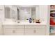 Bathroom featuring a large mirror, vanity with decor, and linen storage at 1972 N Loretta Pl, Casa Grande, AZ 85122