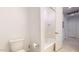 Bathroom with tiled shower and tub, toilet, and entry to the hallway at 1972 N Loretta Pl, Casa Grande, AZ 85122