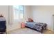 Bedroom showcasing a patterned bed near a bright window and storage cart at 1972 N Loretta Pl, Casa Grande, AZ 85122