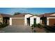 Charming single-story home with a well-manicured front yard and a brick paved driveway at 1972 N Loretta Pl, Casa Grande, AZ 85122