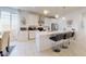 Bright modern kitchen featuring an island with barstools and stainless steel appliances at 1972 N Loretta Pl, Casa Grande, AZ 85122