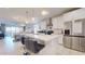 Modern open-concept kitchen features an island with seating and stainless appliances at 1972 N Loretta Pl, Casa Grande, AZ 85122