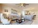 Open-concept living room featuring contemporary furnishings, seamless access to the kitchen, and natural light at 1972 N Loretta Pl, Casa Grande, AZ 85122