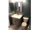 Bathroom featuring a vanity with decorative mirror and a toilet at 21214 N 80Th Ln, Peoria, AZ 85382