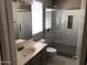 Bathroom with glass shower, modern fixtures, and neutral gray and white color palette at 21214 N 80Th Ln, Peoria, AZ 85382