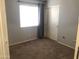 Bedroom featuring neutral walls, carpet, and a closet with sliding doors at 21214 N 80Th Ln, Peoria, AZ 85382