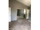 Bedroom with a mirrored closet and neutral carpet at 21214 N 80Th Ln, Peoria, AZ 85382