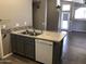 Convenient kitchen island featuring a stainless-steel sink and a new dishwasher at 21214 N 80Th Ln, Peoria, AZ 85382