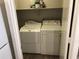 The laundry room features modern appliances and is located next to the kitchen at 21214 N 80Th Ln, Peoria, AZ 85382