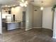 Open-concept living room with wood floors connecting to kitchen with breakfast bar at 21214 N 80Th Ln, Peoria, AZ 85382