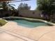 An inviting swimming pool is surrounded by lush landscaping and a spacious deck at 21214 N 80Th Ln, Peoria, AZ 85382