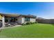 Backyard features include artificial turf, patio and desert landscaping with privacy at 21930 N 29Th St, Phoenix, AZ 85050