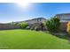 Expansive backyard featuring lush artificial turf, privacy fence, and desert landscaping under a clear sky at 21930 N 29Th St, Phoenix, AZ 85050