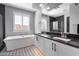 Bright and modern bathroom featuring dual sinks, geometric tile flooring, and a separate tub and shower at 21930 N 29Th St, Phoenix, AZ 85050