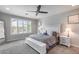 Serene bedroom featuring a ceiling fan, plantation shutters, and a comfortable bed with neutral decor at 21930 N 29Th St, Phoenix, AZ 85050