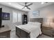 Bedroom featuring a queen bed, ceiling fan, plantation shutters, and a gray color scheme at 21930 N 29Th St, Phoenix, AZ 85050