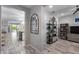 Modern entryway with tile flooring, an arched mirror, and an open view into the dining and living area at 21930 N 29Th St, Phoenix, AZ 85050