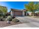 Well-maintained single-story home with desert landscaping, a brick driveway, and two-car garage at 21930 N 29Th St, Phoenix, AZ 85050