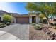 Charming single-story home featuring a brick driveway, two-car garage, and desert landscaping at 21930 N 29Th St, Phoenix, AZ 85050