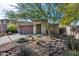 Well-maintained single-story home featuring desert landscaping, including rocks and native plants at 21930 N 29Th St, Phoenix, AZ 85050