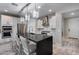 This modern kitchen has stainless steel appliances, pendant lights, and a large island with bar seating at 21930 N 29Th St, Phoenix, AZ 85050