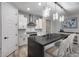 This modern kitchen has a stainless steel range hood, white cabinets, and an island with bar stool seating at 21930 N 29Th St, Phoenix, AZ 85050