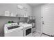 Bright laundry room with modern washer, dryer, shelving, and stylish decor for efficient organization at 21930 N 29Th St, Phoenix, AZ 85050