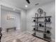 Stylish living area with tile flooring, modern shelving, and an adjacent space featuring a sitting bench at 21930 N 29Th St, Phoenix, AZ 85050