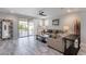 Bright living room with tile floors, neutral furniture, and a sliding glass door to the outdoor patio at 21930 N 29Th St, Phoenix, AZ 85050