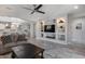 Bright and modern living room with a large television and open layout connecting to the dining and kitchen areas at 21930 N 29Th St, Phoenix, AZ 85050