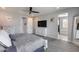Bright main bedroom featuring a ceiling fan, ensuite bathroom, and neutral gray paint at 21930 N 29Th St, Phoenix, AZ 85050