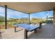 Fun outdoor space with ping pong table under a covered patio, ideal for entertaining guests at 21930 N 29Th St, Phoenix, AZ 85050