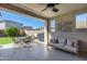 Inviting covered patio featuring comfortable seating, outdoor dining, and backyard view with desert landscaping at 21930 N 29Th St, Phoenix, AZ 85050
