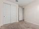 Bedroom with sliding closet doors features a door frame and carpeted floor at 2464 N Morrison Ave, Casa Grande, AZ 85122