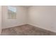 Bright bedroom with a window with blinds and carpeted floors at 2464 N Morrison Ave, Casa Grande, AZ 85122