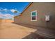 Exterior shot shows backyard, fence and side of house with window and water heater at 2464 N Morrison Ave, Casa Grande, AZ 85122