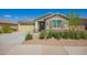 Charming single-story home with a neutral exterior, low maintenance landscaping, and a two-car garage at 2464 N Morrison Ave, Casa Grande, AZ 85122