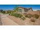 Single-story residence with low water landscaping, a neutral stucco exterior, stone accents, and a gray roof at 2464 N Morrison Ave, Casa Grande, AZ 85122