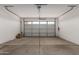 Spacious two car garage with concrete floors, and an insulated garage door with windows at 2464 N Morrison Ave, Casa Grande, AZ 85122
