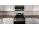 Close-up of a modern stainless steel oven range with a sleek microwave and bright white cabinets above at 2464 N Morrison Ave, Casa Grande, AZ 85122