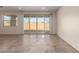 Bright, airy living room with tile flooring, sliding glass doors to the backyard, and ample natural light at 2464 N Morrison Ave, Casa Grande, AZ 85122