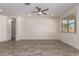 Spacious living room with tile flooring, modern ceiling fan, and abundant natural light from windows at 2464 N Morrison Ave, Casa Grande, AZ 85122