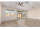 Expansive living room features tile floors, modern ceiling fan, and sliding glass doors with backyard view at 2464 N Morrison Ave, Casa Grande, AZ 85122
