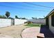 Spacious backyard with artificial turf, brick accents, white block wall, and outdoor grill at 2614 W Greenway Rd, Tempe, AZ 85282
