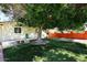 Spacious backyard with artificial grass, mature tree, and a bench at 2614 W Greenway Rd, Tempe, AZ 85282