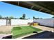 View of the backyard featuring artificial turf, BBQ area, and block wall at 2614 W Greenway Rd, Tempe, AZ 85282