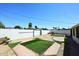 Spacious backyard with artificial turf, brick accents, and a white block wall at 2614 W Greenway Rd, Tempe, AZ 85282