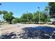 Two basketball courts with hoops, blue accents, and tall lights are surrounded by mature trees at 2614 W Greenway Rd, Tempe, AZ 85282